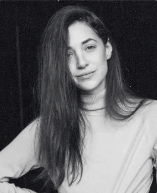 Lee Rubin in a pale turtleneck, long hair over one shoulder, against a dark backdrop
